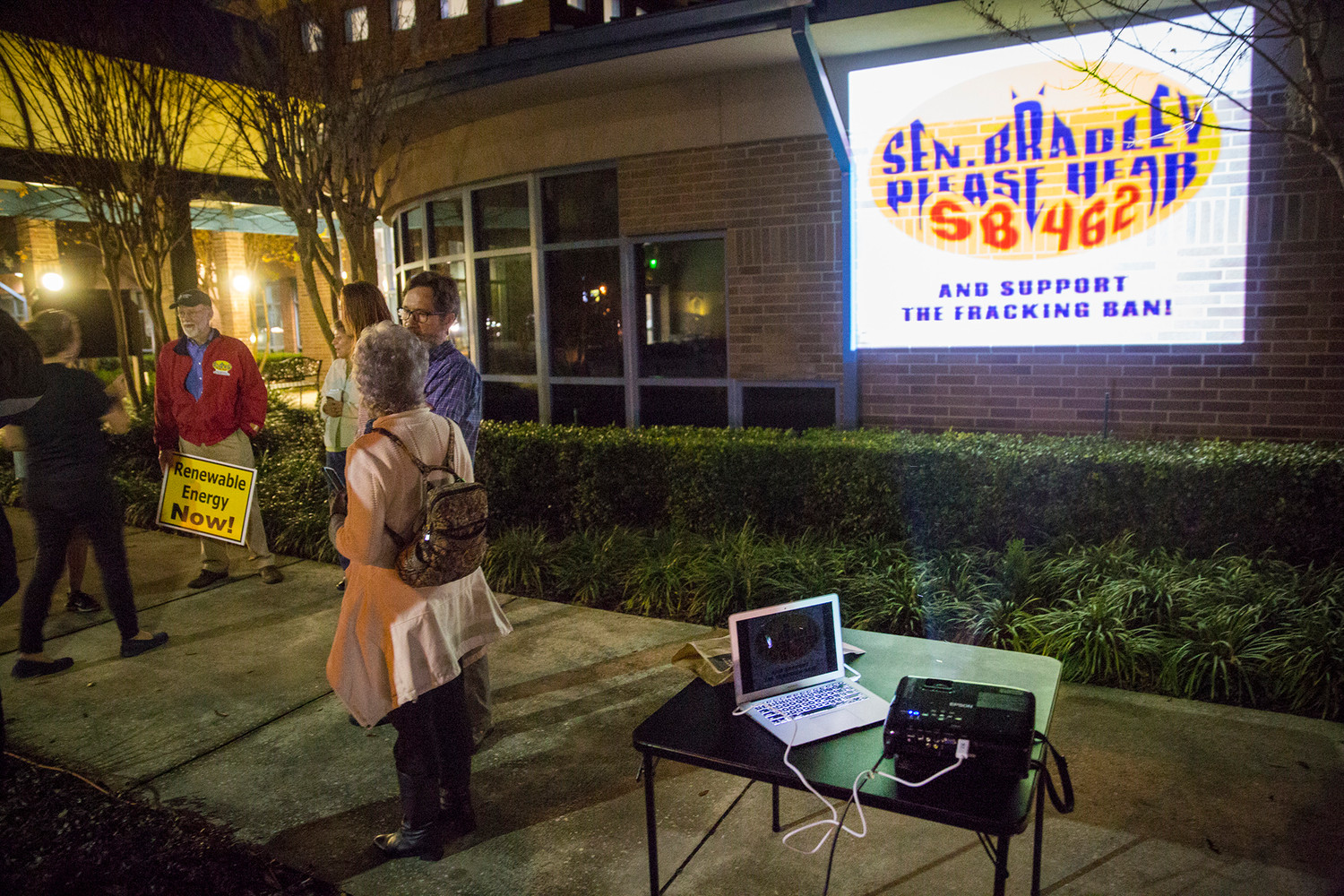 A group containing Sierra Club members and Doug Miller of reThink Energy Florida met outside Orange Park Town Hall last Thursday evening to project a Bat Signal-style graphic onto the building calling for Sen. Rob Bradley's help in passing Senate Bill 462 and keep fracking out of Florida.