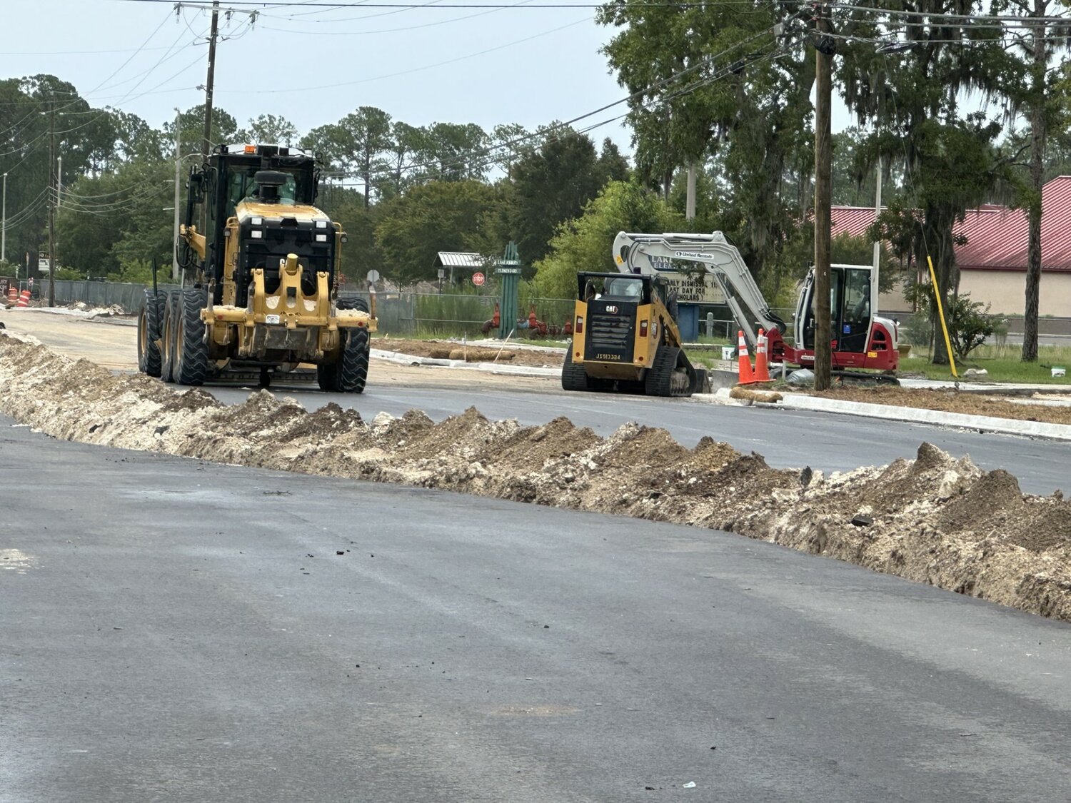 Workers only need to put a final layer of asphalt and add striping to complete the Sandridge Road expansion at the Henley Road intersection. The barriers will be removed at Eagle Haven Drive and Jubilee Lane at 11 p.m. on July 30, and work will immediately move to start the 
second phase from Lake Asbury Elementary to Russell Road Baptist Church the next day.