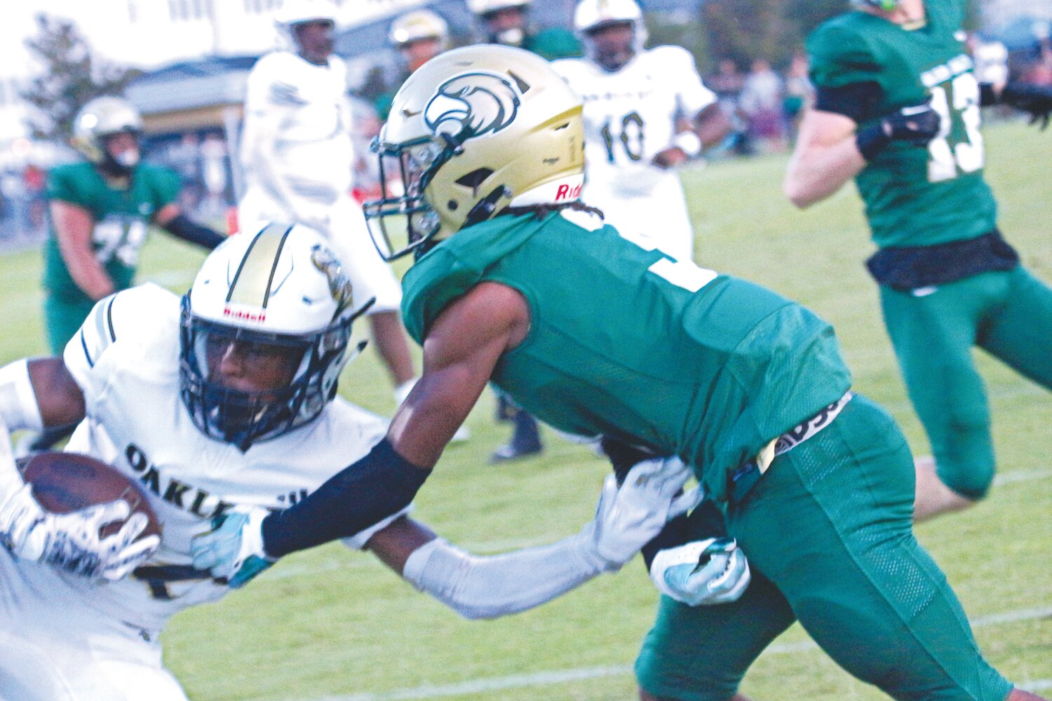 Oakeaf High defensive back Jordin Pryce, in white, steals end zone pass attempt to Fleming Island wide receiver Trace Burney in first-half action of Knights’ 24-14 district win Friday night.