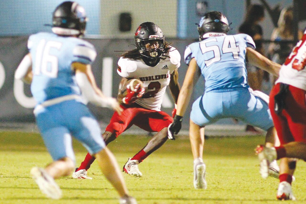 Middleburg High running back Jaden Boyd looks for a sliver between two Ponte Vedra tacklers in the Broncos’ 35-0 loss on Friday.
