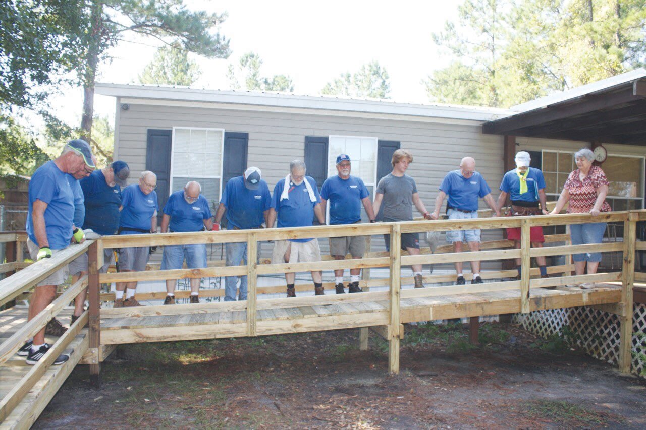 After the job is completed, the James Boys christen the ramp with a prayer, holding hands in unison with each resident they serve. The group has served residents free of charge.
